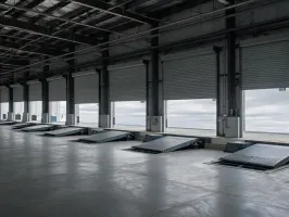 Cross-dock warehouse with hydraulic dock leveler pits